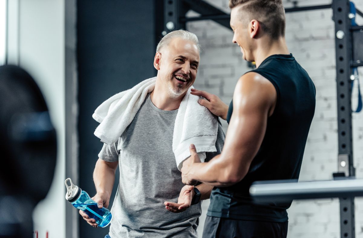 Image of older male and younger gent working out in the gym.